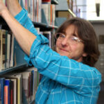 Photograph of Trisha Cantwell in library stacks.